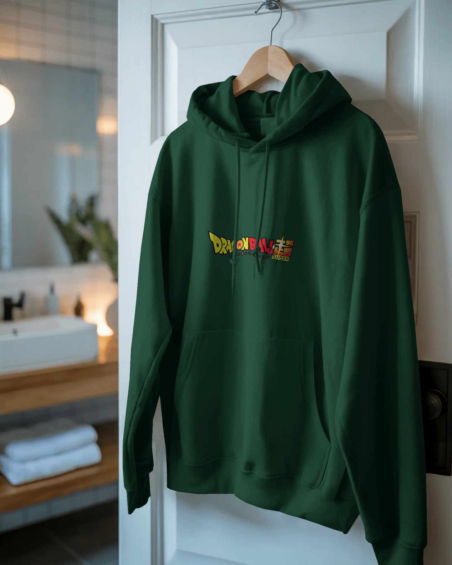 Green hoodie with colorful text design hanging on a door in a room.