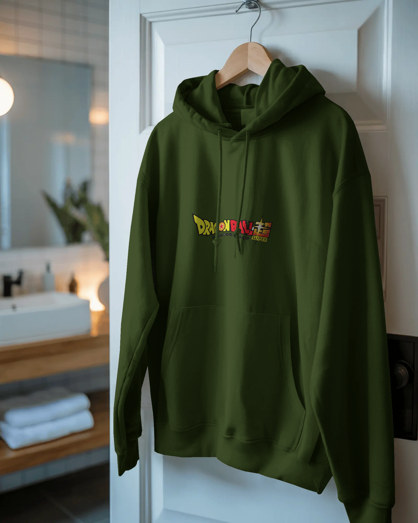 Green hoodie with colorful text design hanging on a door in a room.