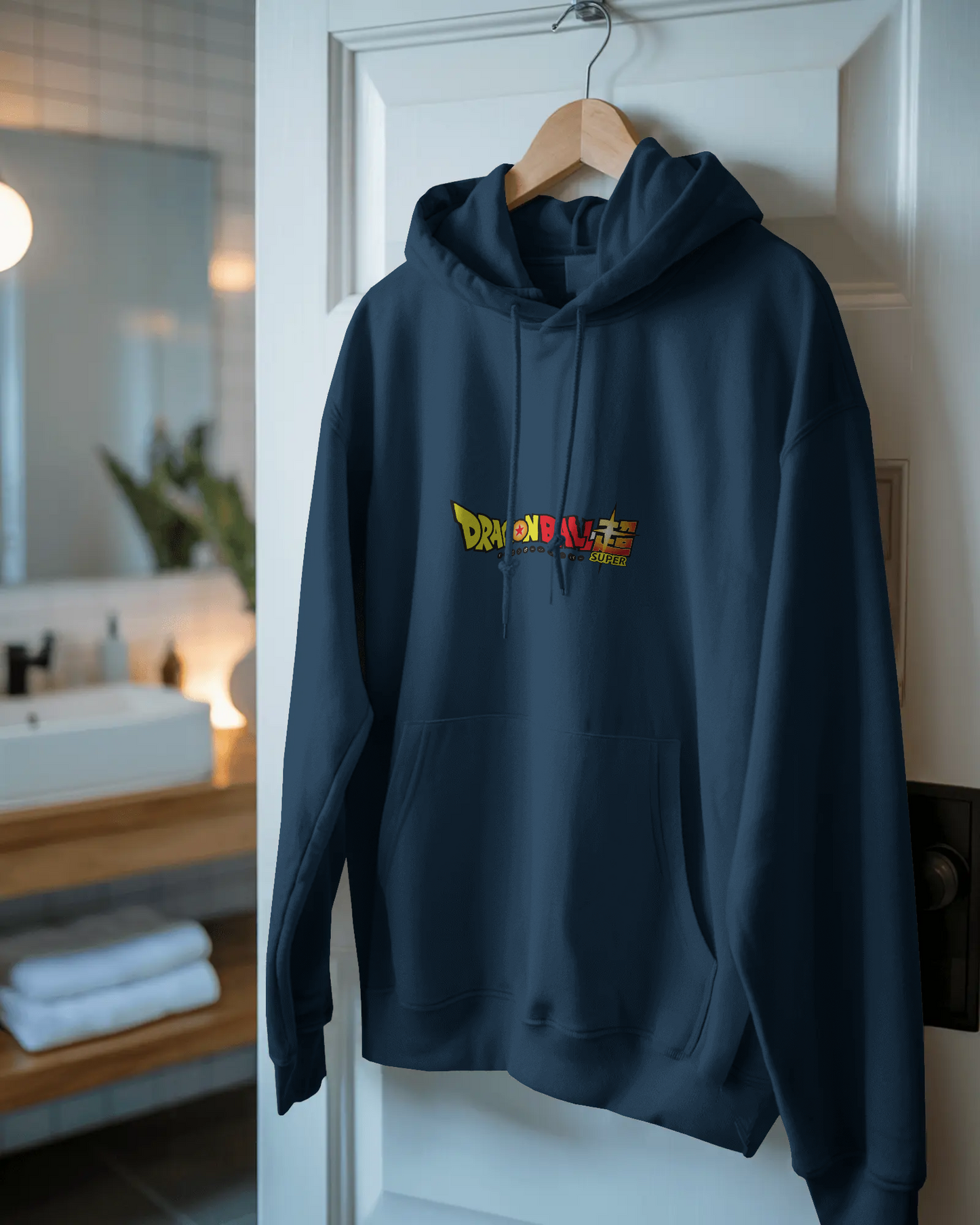 Navy blue hoodie with colorful text design on a hanger against a white door.