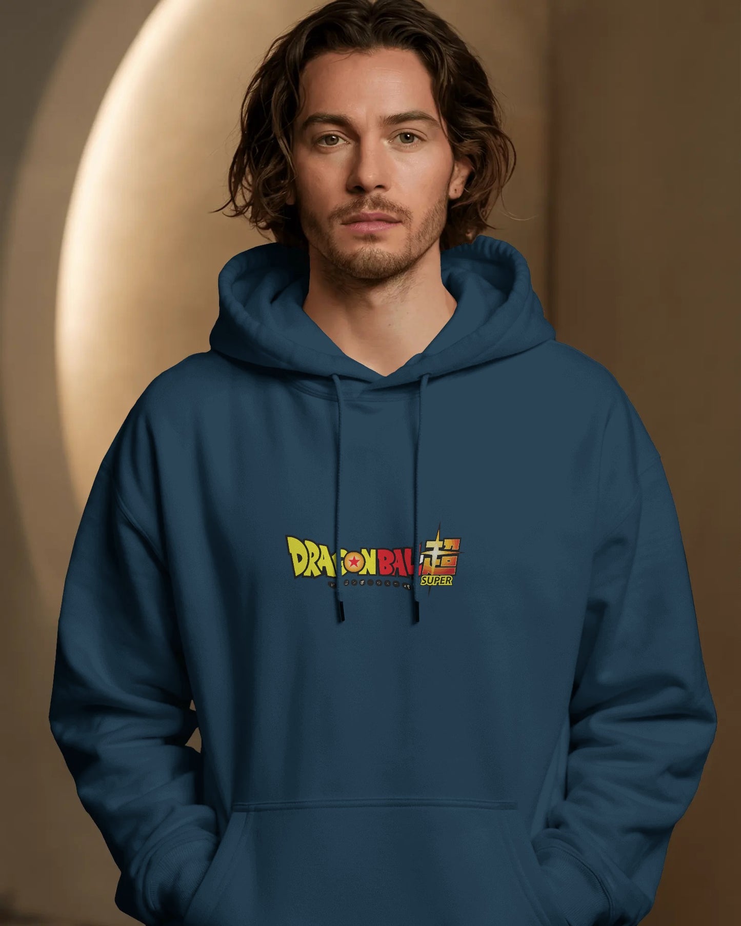 Man wearing a blue hoodie with a colorful logo on a brown background